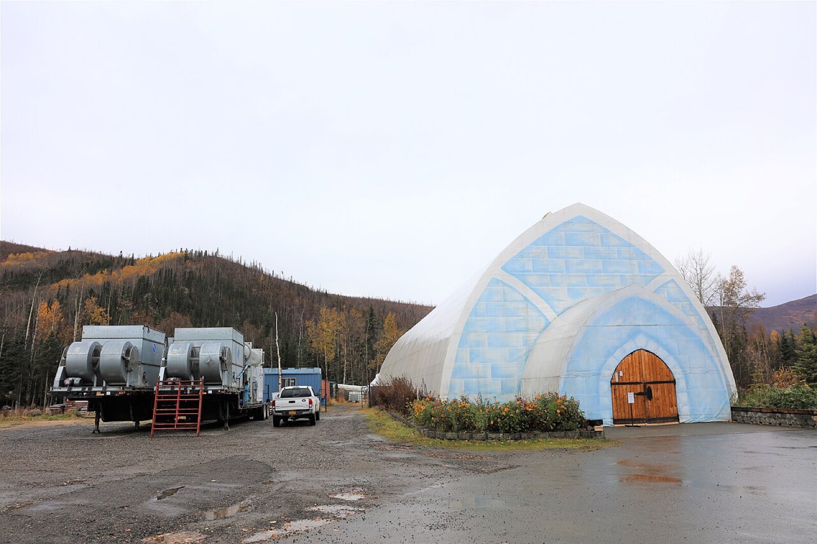 Buildings at Chena Hot Springs Resort in autumn, including a white domed building, with birch-covered hills behind