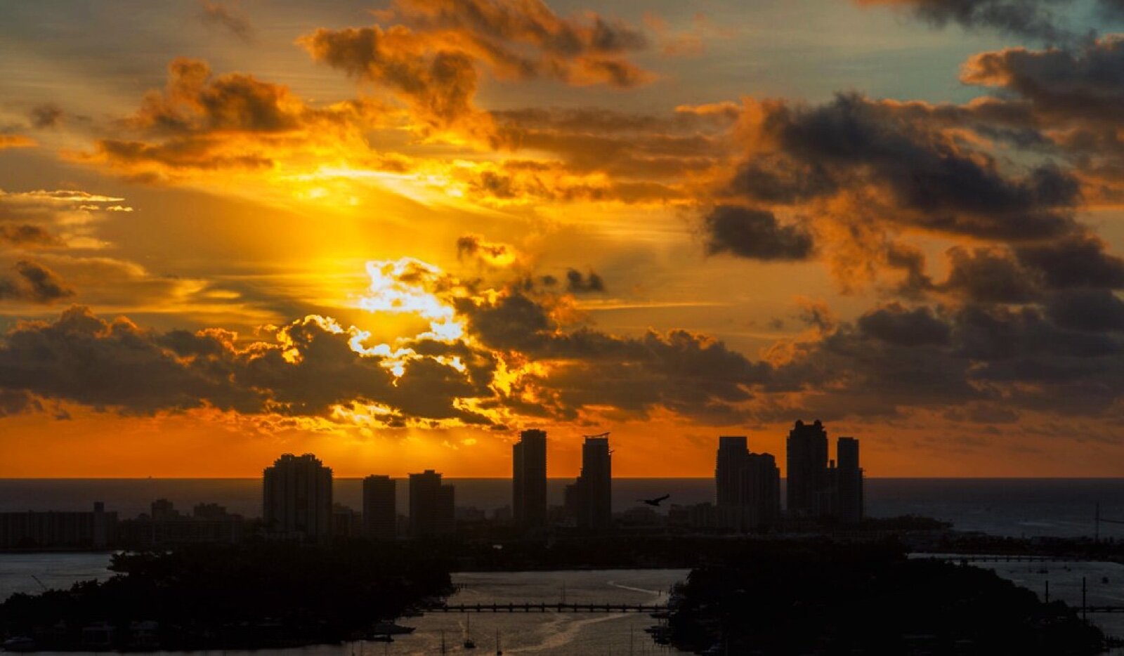 Sunrise over the Atlantic behind the South Beach skyline in Miami, Florida