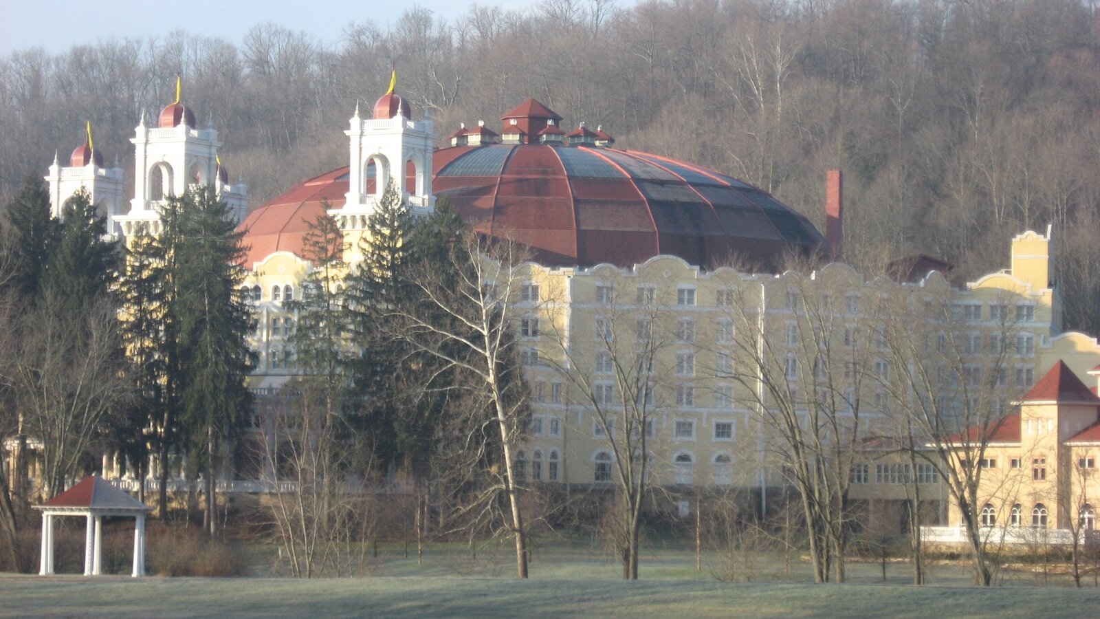 West Baden Springs Hotel and its red dome among bare trees at dawn, southern Indiana