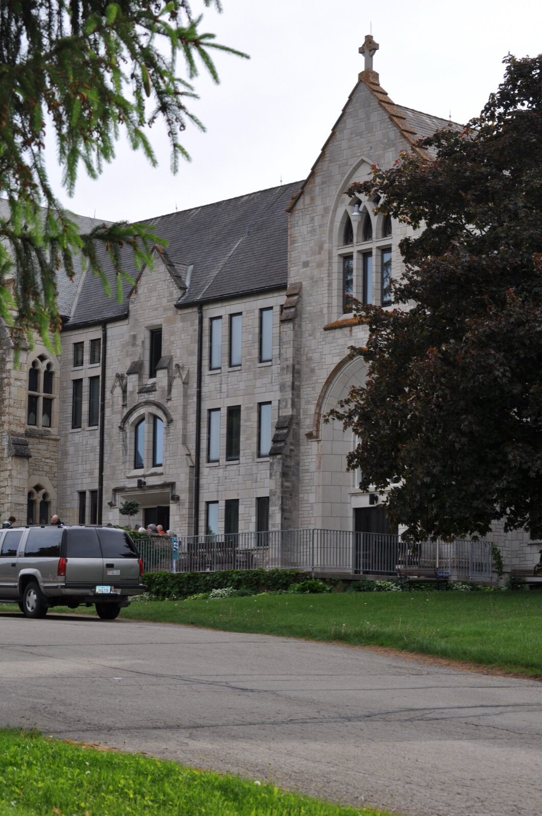 The pale stone Gothic buildings of New Melleray Abbey near Dubuque, Iowa, framed by trees