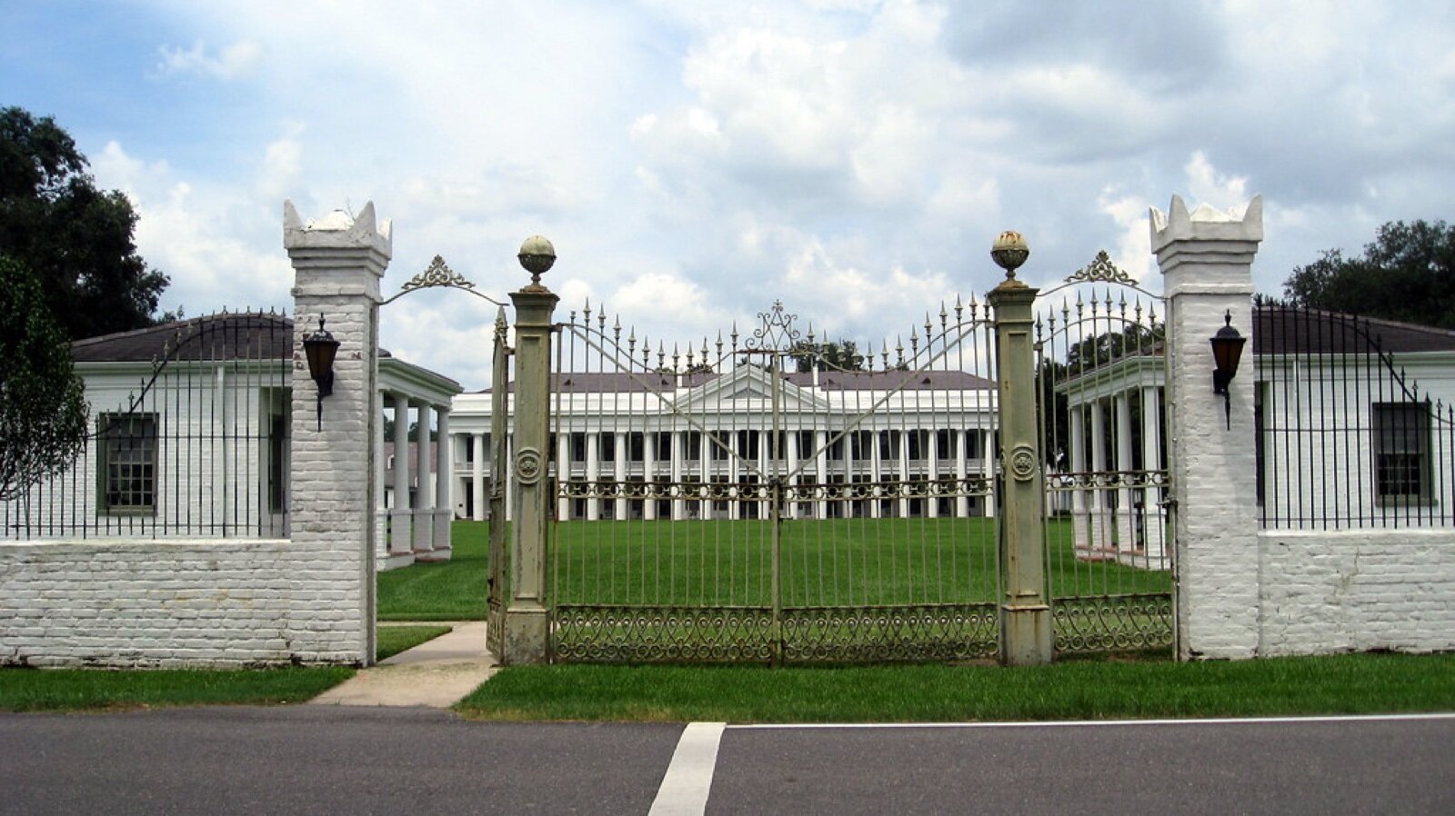 Wrought iron gates in front of the white columned main building of Manresa House of Retreats in Convent, Louisiana