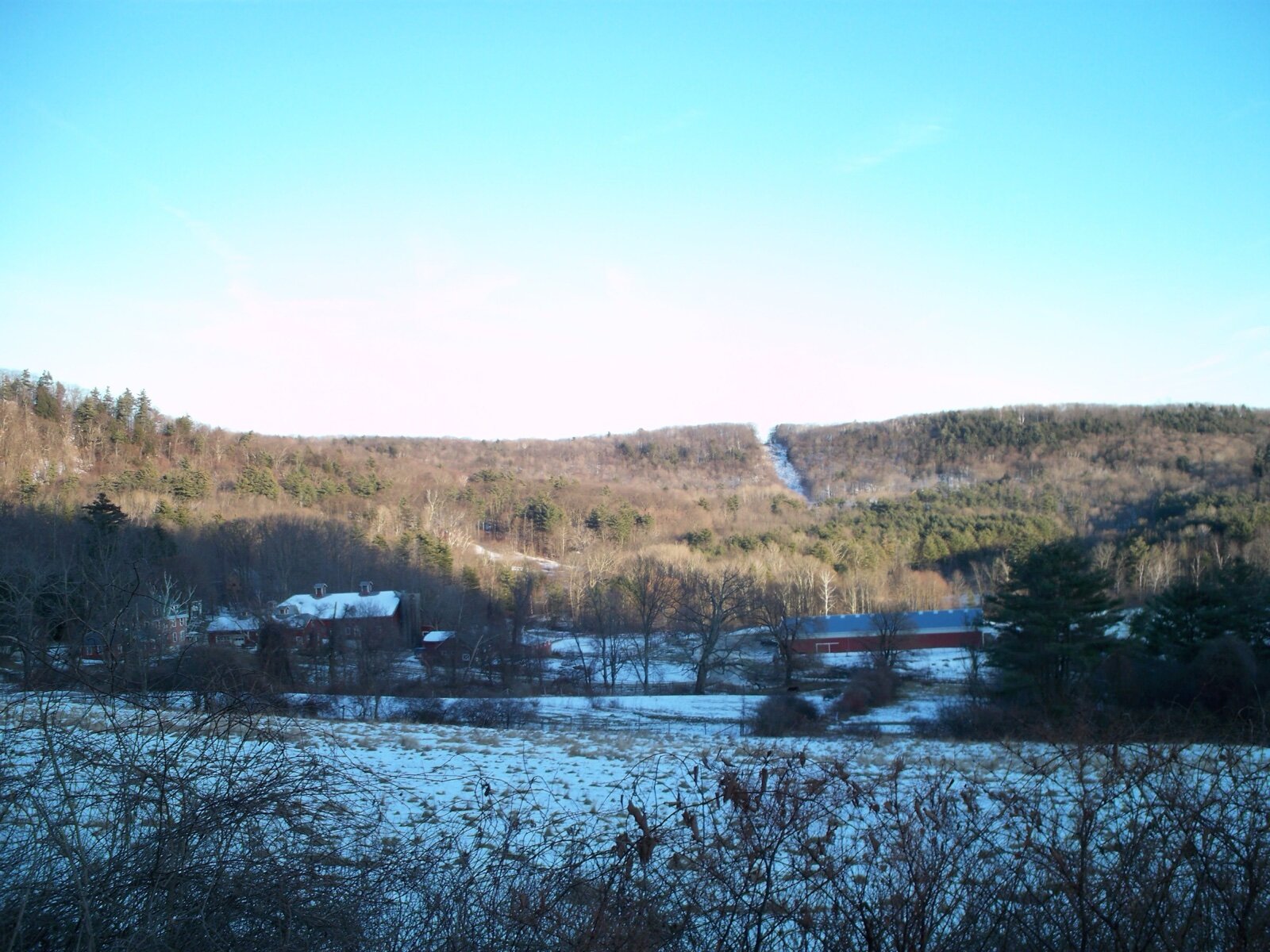 Farm buildings and wooded hills along Under Mountain Road in Lenox, in the Berkshire Hills of Massachusetts