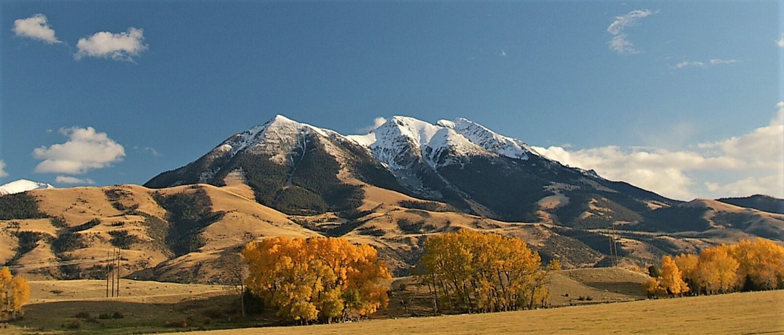 Emigrant Peak rising above the golden foothills and cottonwoods of Paradise Valley, Montana