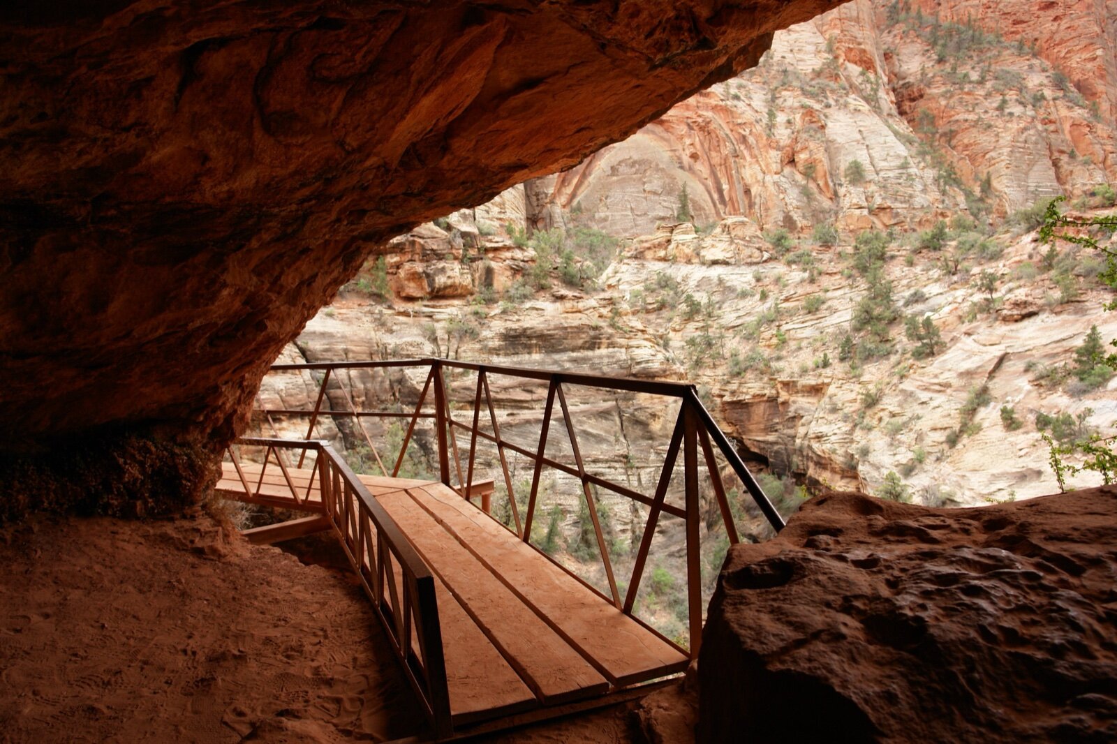 Red sandstone cliffs and a walkway on the Canyon Overlook trail in Zion National Park, southern Utah